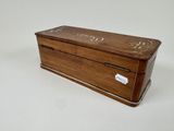 an old wooden box with a label on the lid