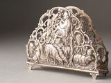a silver plate with a design on it on a table
