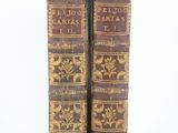 pair of antique leather bound books on a white background