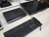 a computer desk with a keyboard, monitor, and laptop on it