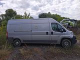 a silver van that is parked in the grass