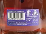 a close up of a bottle of liquid with a barcode on it