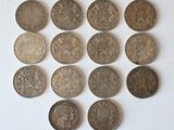 several different types of coins are arranged in a circle on a white surface
