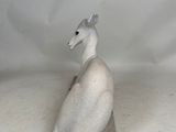 a statue of a bird sitting on top of a table