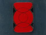 an image of a red and black object on a blue surface