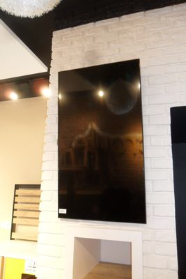 a picture of a living room with a television on the wall