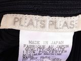 the label of a black dress with a white label on it