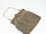 an image of a brown purse on a white surface