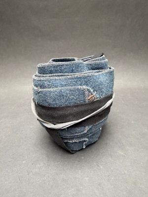 a stack of blue jeans stacked on top of each other
