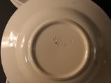 a close up of a white plate with a saucer on it