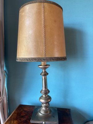 a lamp that is sitting on a table in front of a window