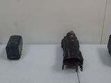 four toy trains sitting on a table next to each other