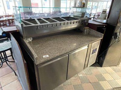 a counter with a sink and a counter top in a restaurant
