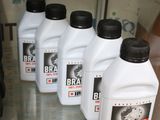 five bottles of brake fluid on display in a glass case