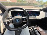 a steering wheel and dashboard of a car with a view of the street