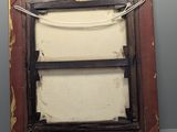 an old picture frame with a rope hanging from it ' s side