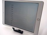a tablet that is sitting on a stand on a table