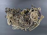 a pile of assorted beads and jewelry on a table