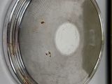a silver plate with a book on it next to it