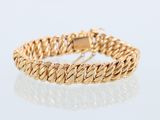 a yellow gold bracelet with a braid design on a white background