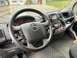 dashboard view of a vehicle with a steering wheel and dashboard controls