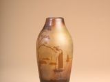 a vase with a painting on it sitting on a table