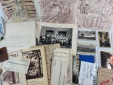 a lot of old photos and postcards on the table