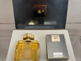 an image of a bottle of perfume sitting on top of a table