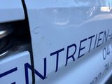 a close up of a white van with the word entretenent written on it