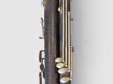 a close up of a clarinet with a wooden case