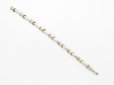 un bracelet en argent et en or au motif circulaire