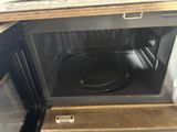 a microwave that is open and has a plate inside of it