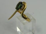 an image of a gold ring with a green tourmaline stone on it