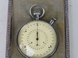 a silver pocket watch in a box on a table
