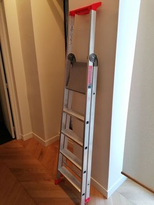 a ladder that is leaning against a wall in a room