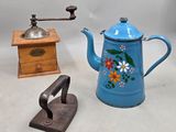 a blue teapot and a wooden grinder next to each other