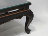 a black table with a glass top on a white background