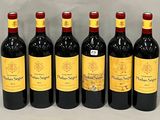six bottles of red wine lined up in a row on a table