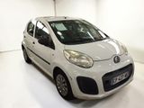 a picture of a small white car parked in a garage