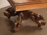 a wooden table with a carved animal on top of it