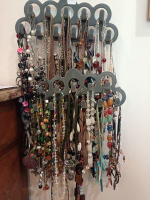 a picture of a rack of necklaces hanging on a wall