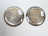 pair of silverplated bowls with labels on them on a table