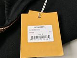 a tag on a black shirt with a barcode on it