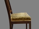 a wooden chair with a yellow seat on a gray background