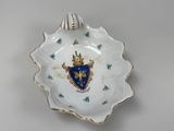 a white plate with a blue and gold crest on it