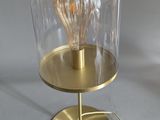 a lamp that is on a stand with a light bulb