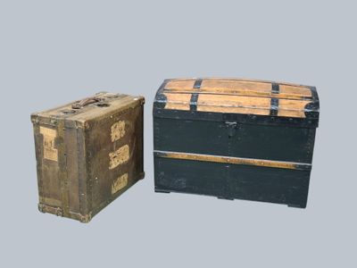 two trunks sitting next to each other on a gray surface