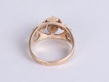a close up of a gold ring with a diamond in the center