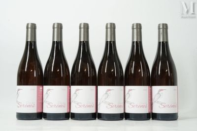 six bottles of wine lined up in a row on a table