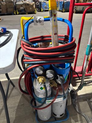 a cart with a bunch of gas bottles and hoses